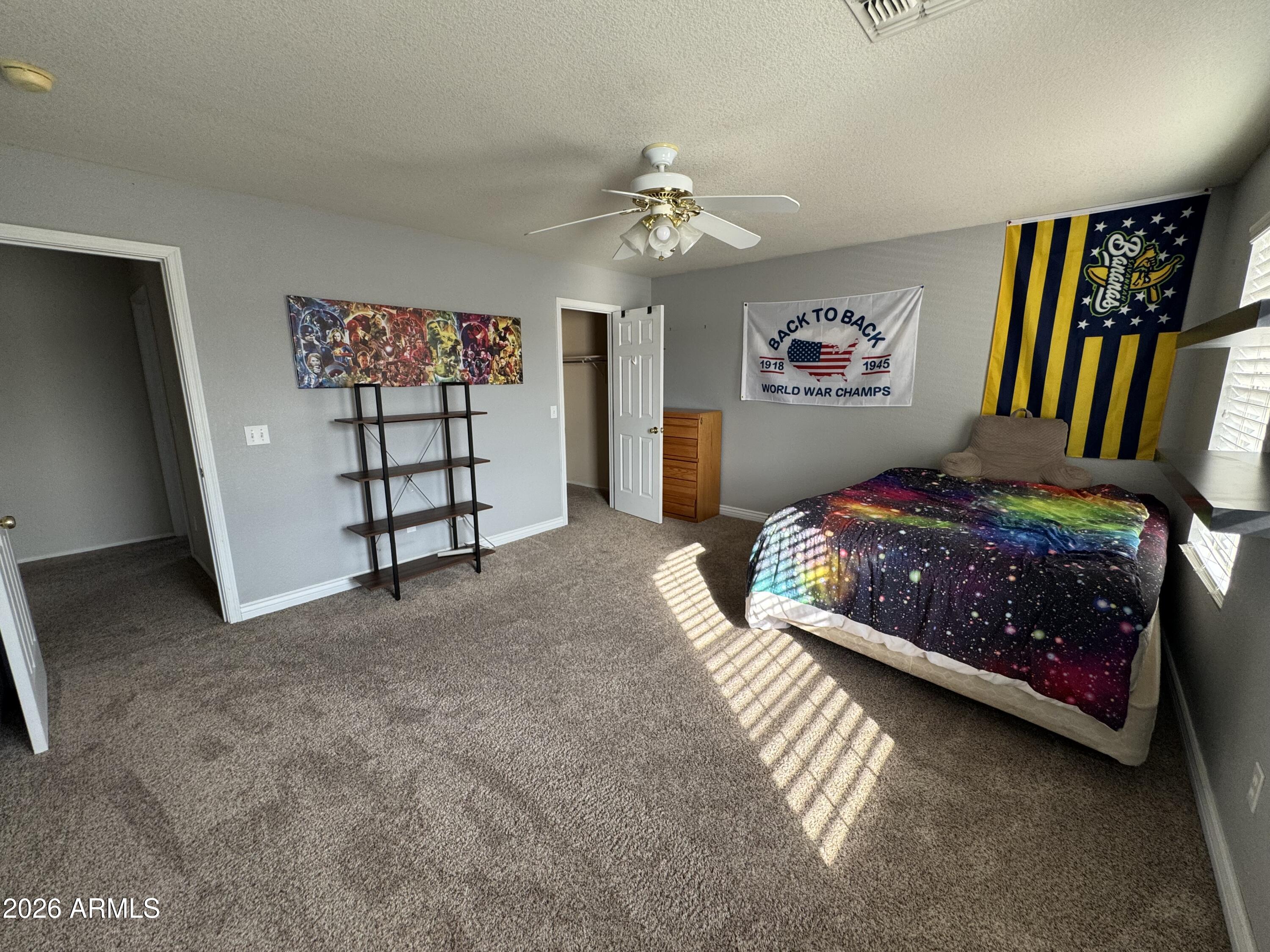 3750 East Orchid Lane Gilbert, AZ 85296 - Photo 30 of 43 a bedroom with a bed and a book shelf