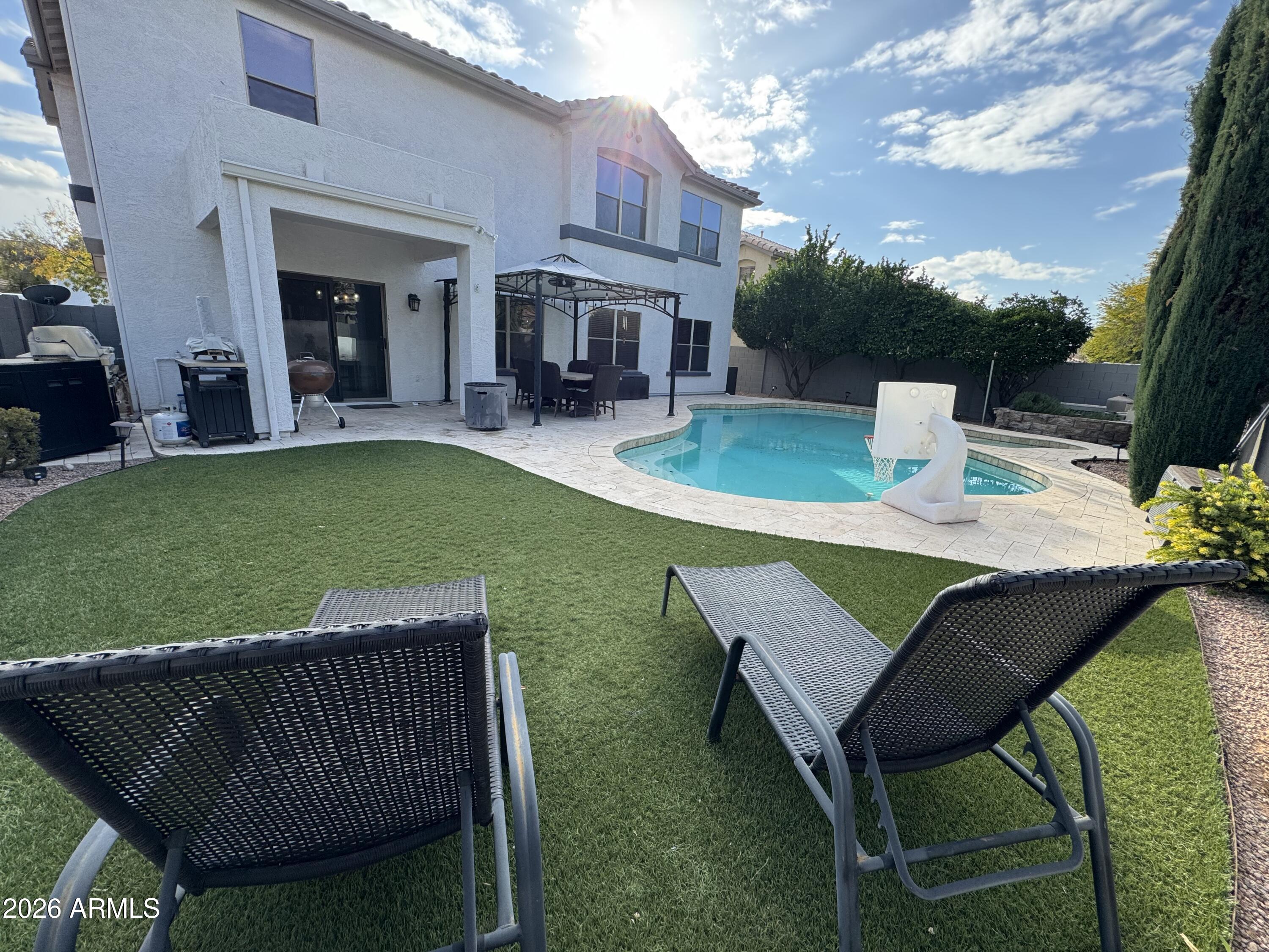 3750 East Orchid Lane Gilbert, AZ 85296 - Photo 39 of 43 a view of a patio with couches chairs and a table and chairs