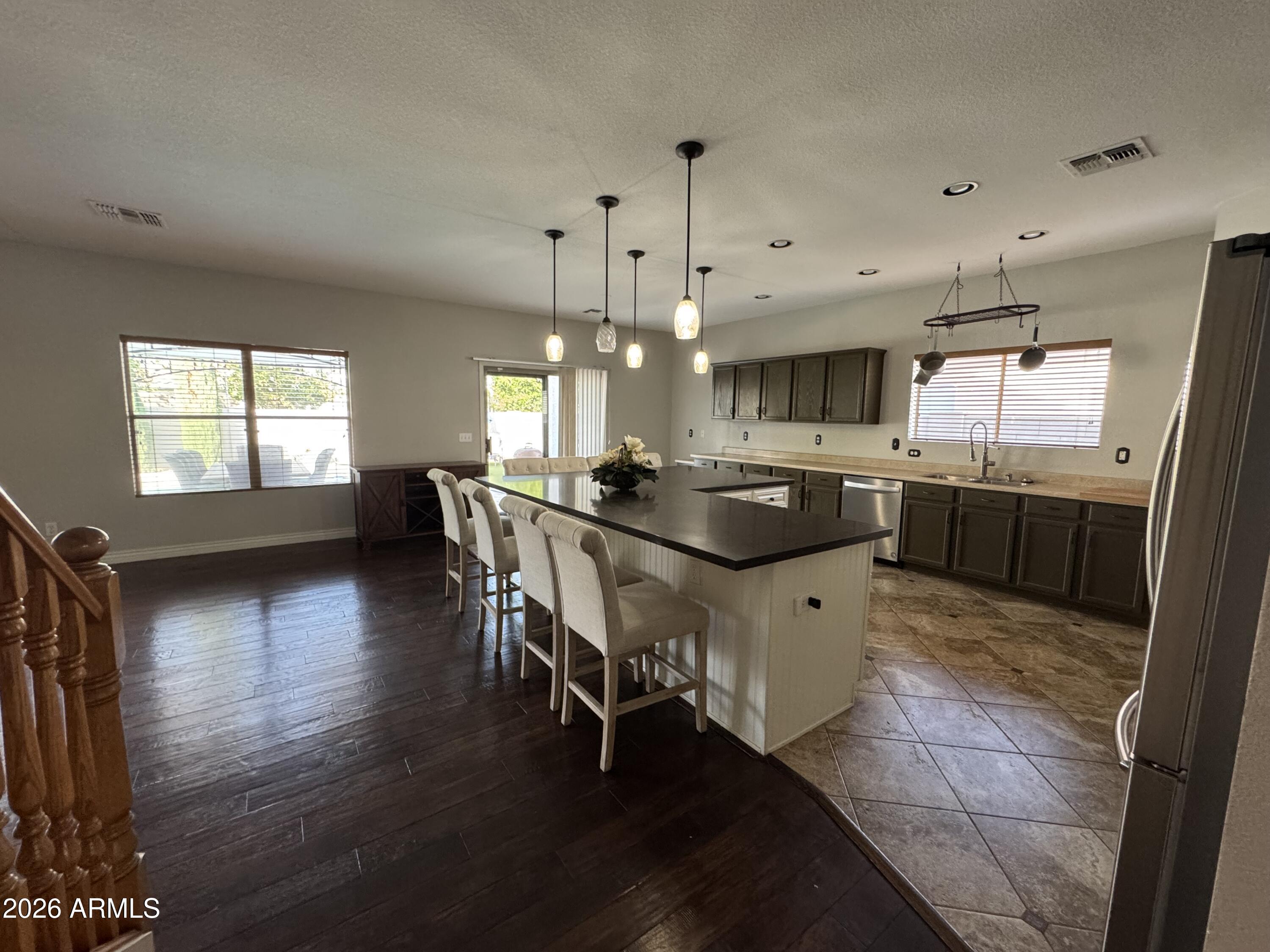 3750 East Orchid Lane Gilbert, AZ 85296 - Photo 4 of 43 a kitchen with stainless steel appliances granite countertop a sink counter space and wooden floor