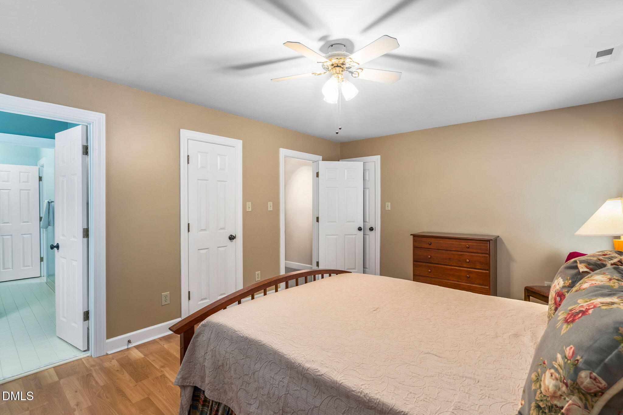1405 October Road Raleigh, NC 27614 - Photo 19 of 40 a bedroom with a large bed and a chandelier