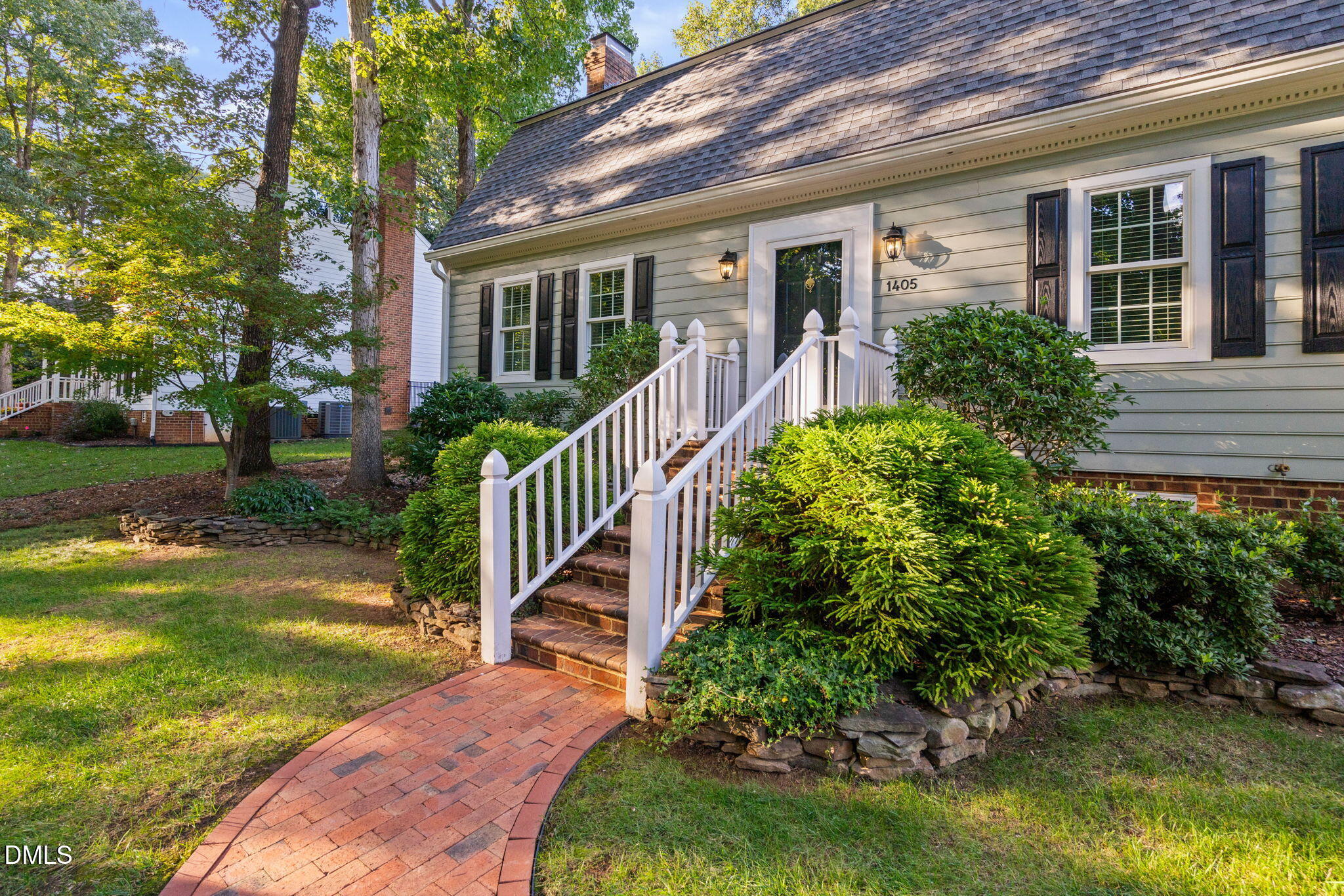 1405 October Road Raleigh, NC 27614 - Photo 2 of 40 a view of a house with brick walls plants and large tree