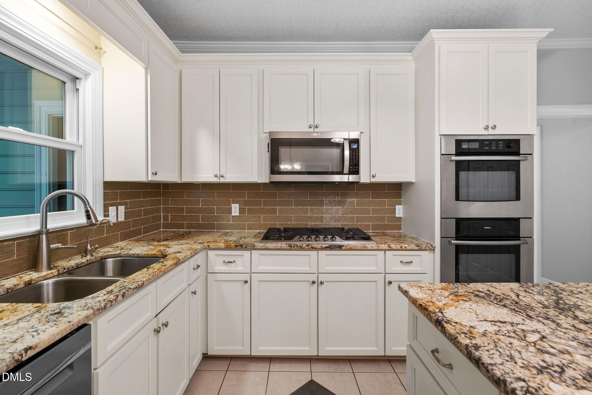 1405 October Road Raleigh, NC 27614 - Photo 9 of 40 a kitchen with granite countertop a sink stove and refrigerator