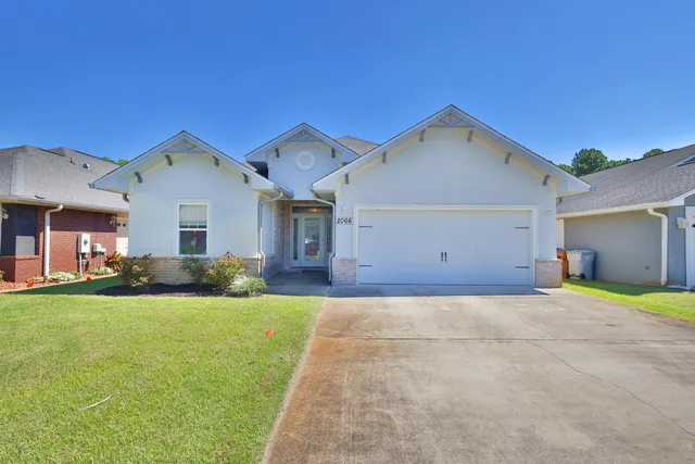 a view of a house with a yard and garage