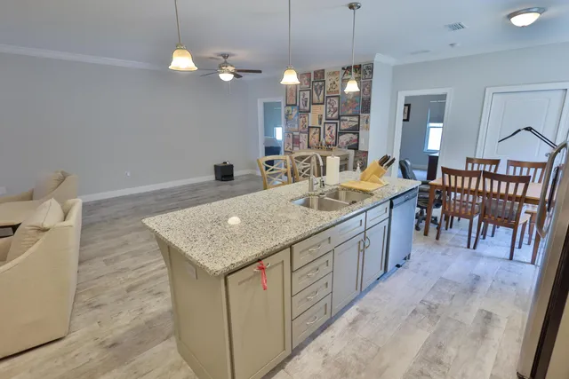 a kitchen with center island table and chairs