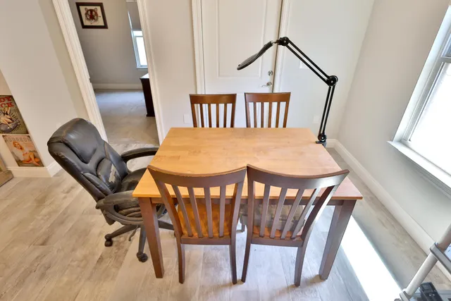 a view of a room with furniture wooden floor and windows
