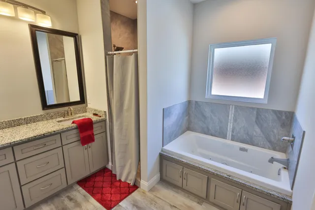 a bathroom with a bathtub and shower