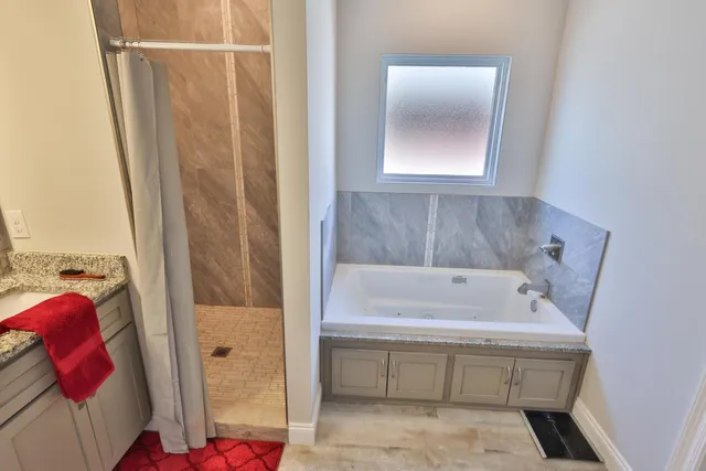 a bathroom with a tub and shower