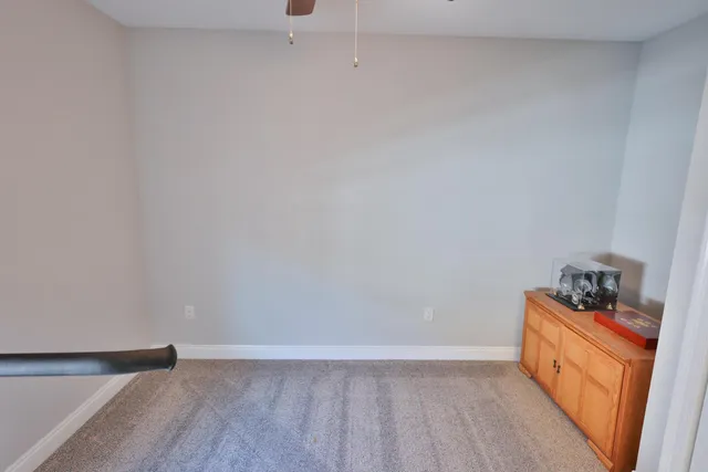 a room with wooden floor and cabinets