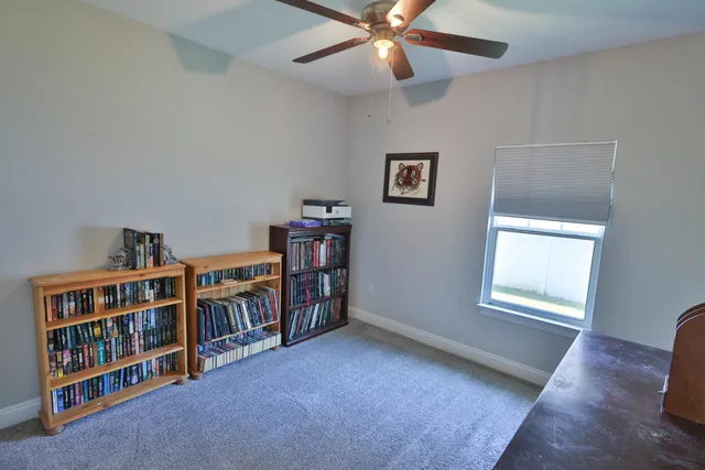 a view of a livingroom with a bookshelf and a window