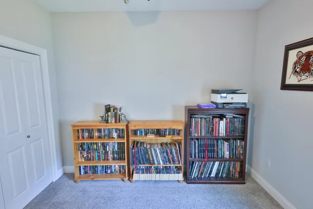 a living room with lots of furniture and baby book shelf