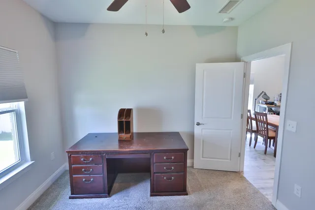 a view of a workspace with furniture and wooden floor