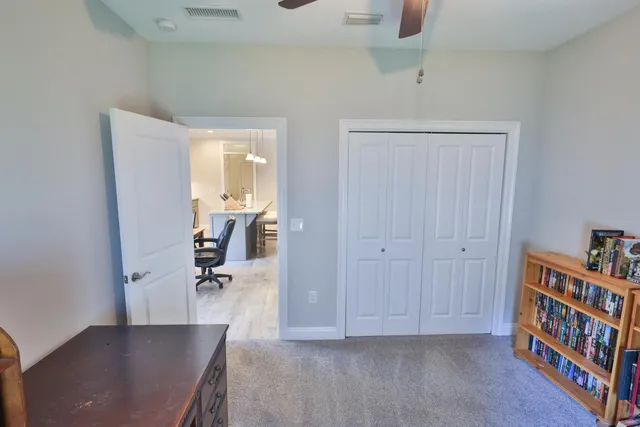 a livingroom with a book shelf and a workspace