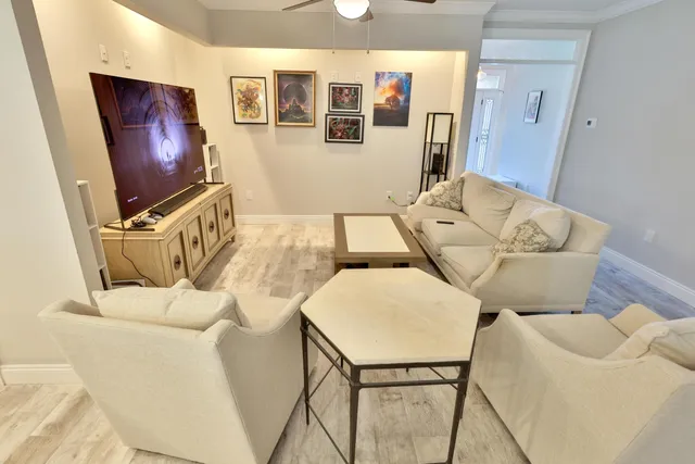 a living room with furniture and flat screen tv