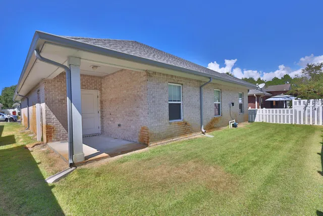 a swimming pool with outdoor seating and yard