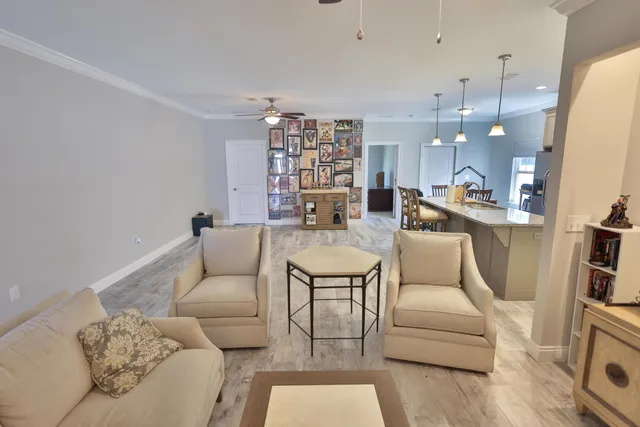 a living room with furniture a rug and white walls