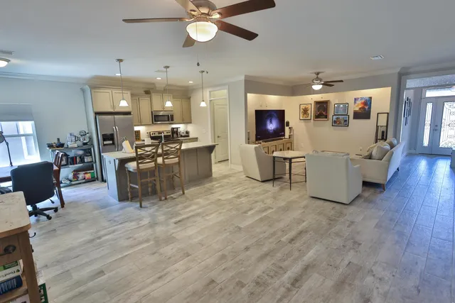 a living room with furniture and kitchen view