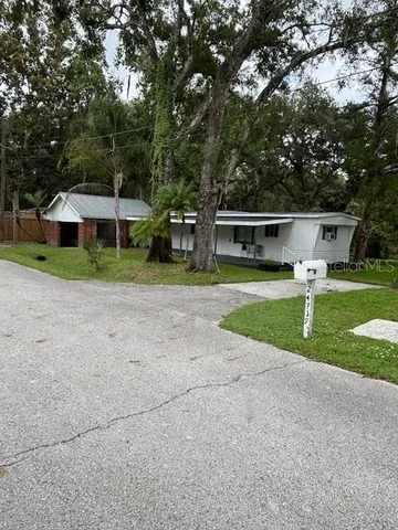 a view of a house with a yard and sitting area
