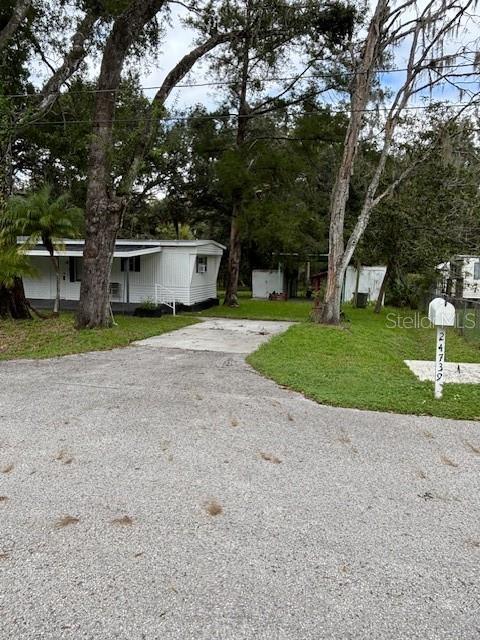 24739 Audrey Road Land O' Lakes, FL 34639 - Photo 13 of 20 a view of a house with a yard and large trees