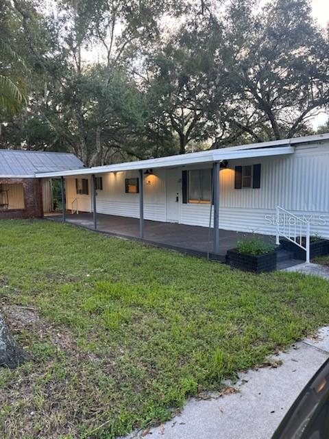 24739 Audrey Road Land O' Lakes, FL 34639 - Photo 3 of 20 a view of a backyard with plants and large tree