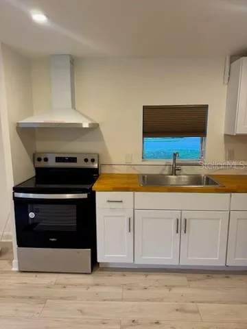 a stove top oven sitting inside of a kitchen
