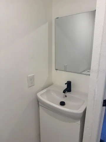a bathroom with a sink and mirror