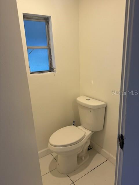 24739 Audrey Road Land O' Lakes, FL 34639 - Photo 10 of 20 a white toilet sitting next to a wooden cabinet