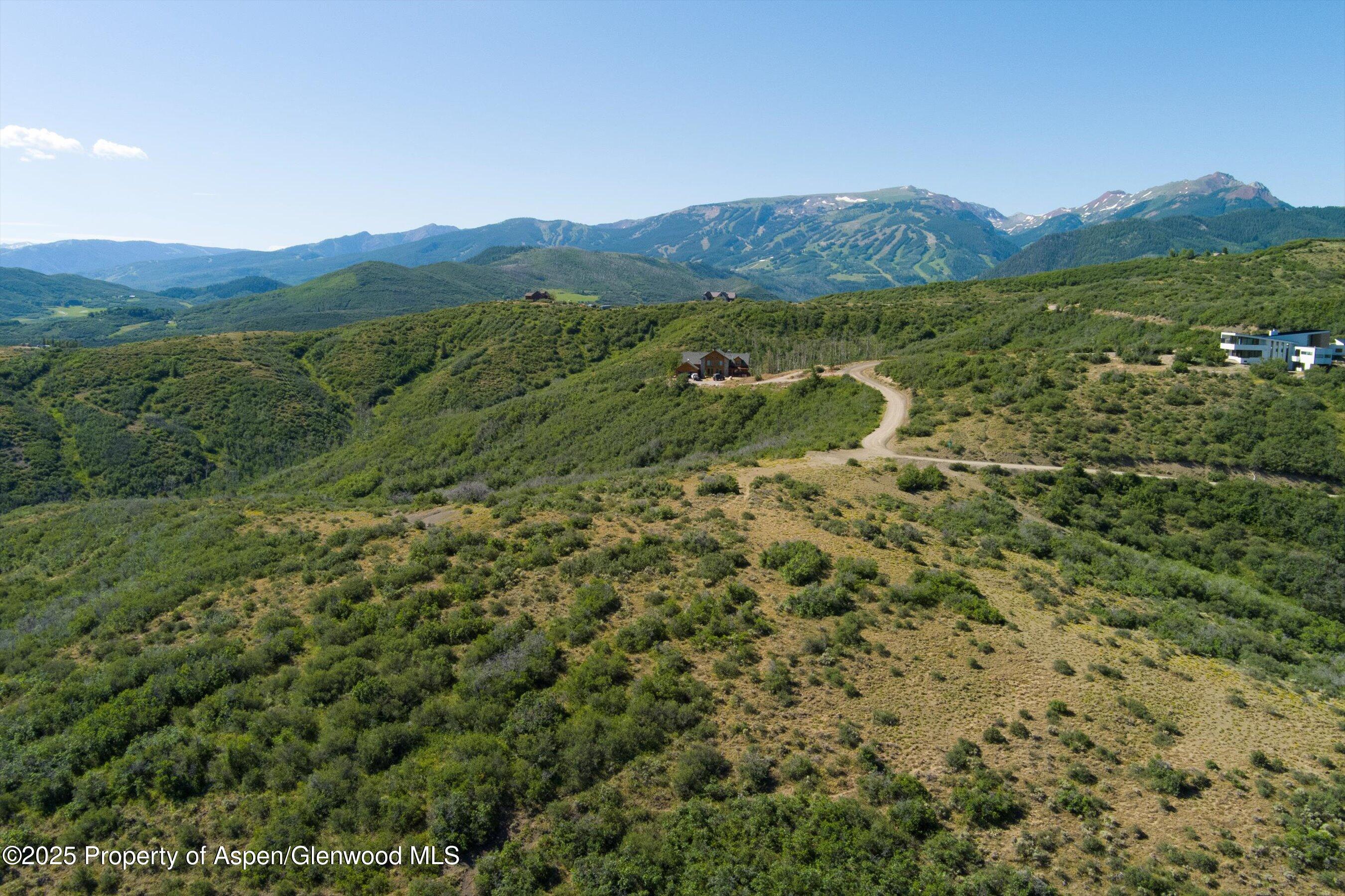 Tbd Monastery Road Snowmass, CO 81654 - Photo 11 of 26 a view of a lush green hillside and houses