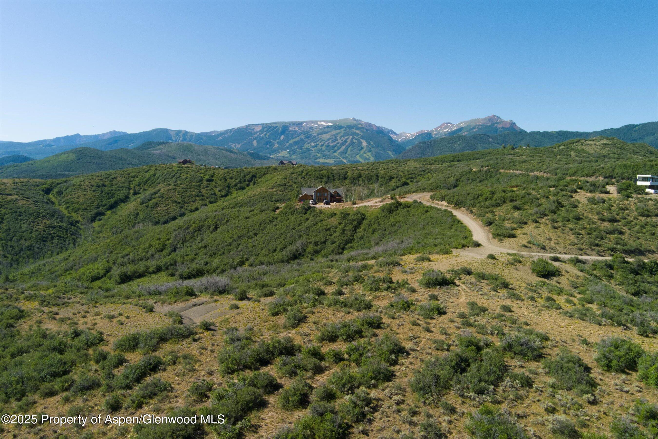 Tbd Monastery Road Snowmass, CO 81654 - Photo 3 of 26 a view of a lush green field with lots of bushes