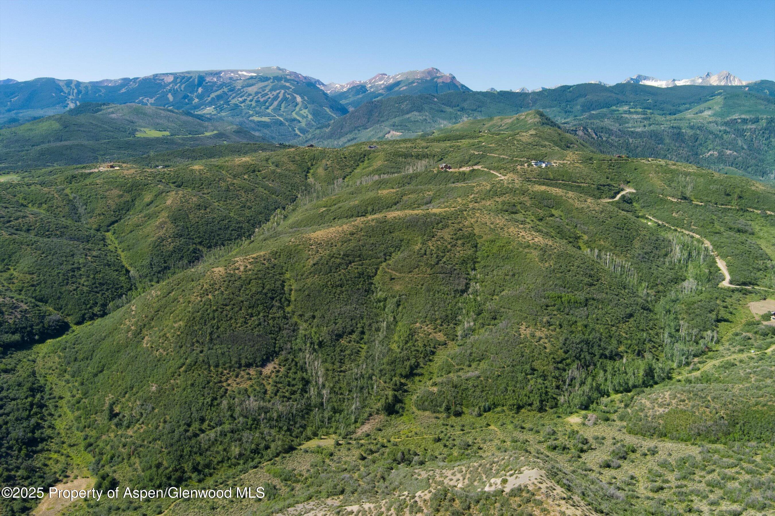 Tbd Monastery Road Snowmass, CO 81654 - Photo 4 of 26 a view of a lush green hillside and houses