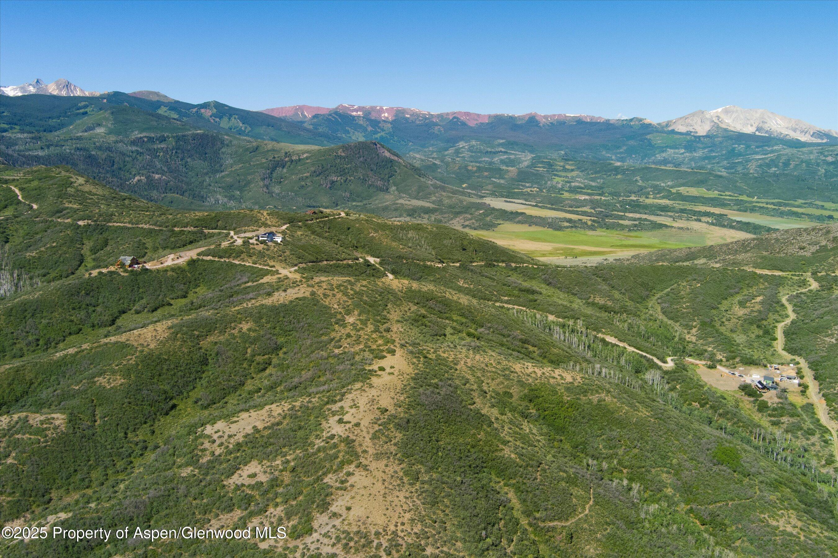 Tbd Monastery Road Snowmass, CO 81654 - Photo 7 of 26 a view of a lush green hillside and mountains
