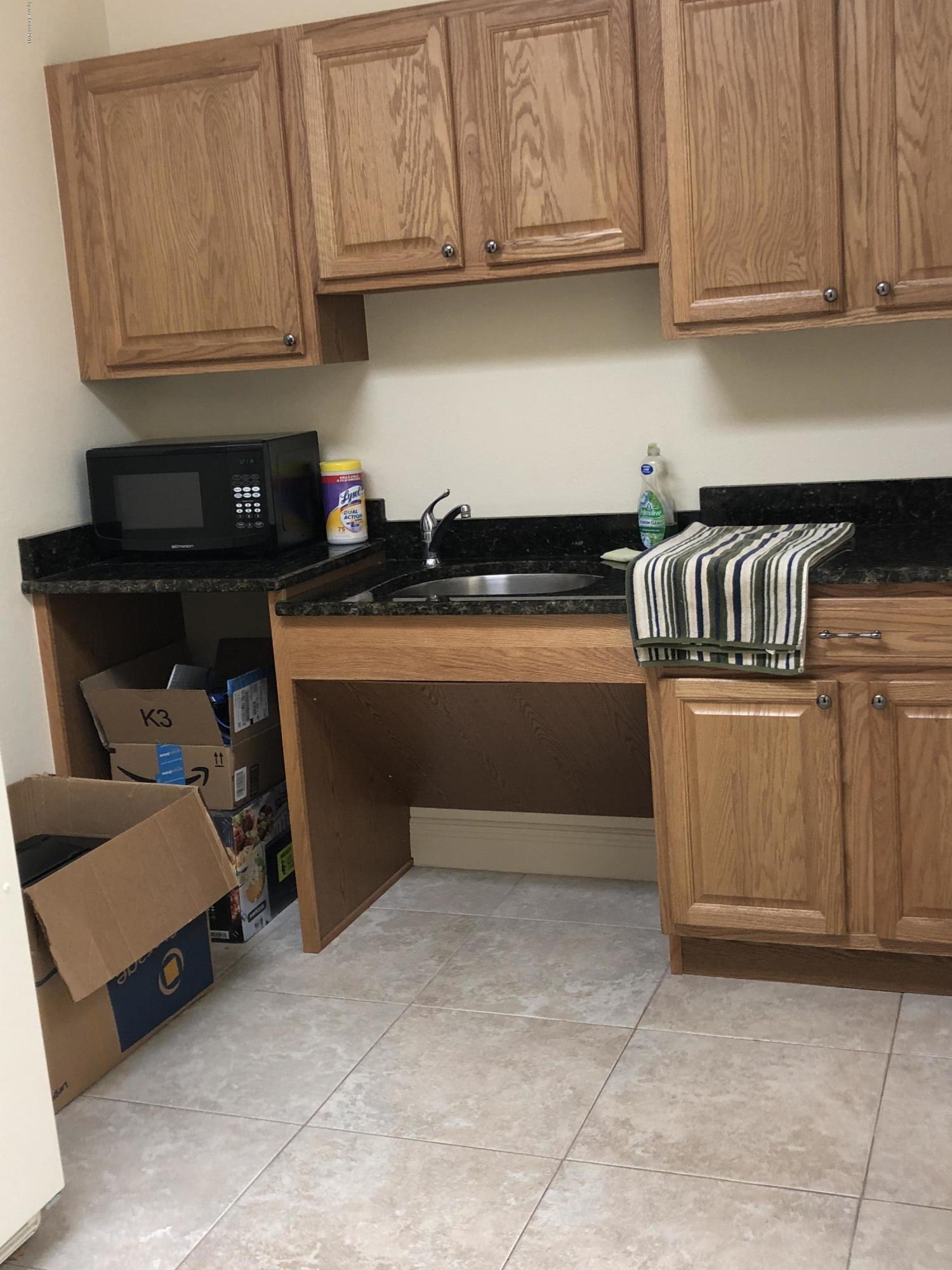 7125 Turner Road, Unit 102 Rockledge, FL 32955 - Photo 5 of 11 a kitchen with stainless steel appliances granite countertop a sink a stove and dishwasher