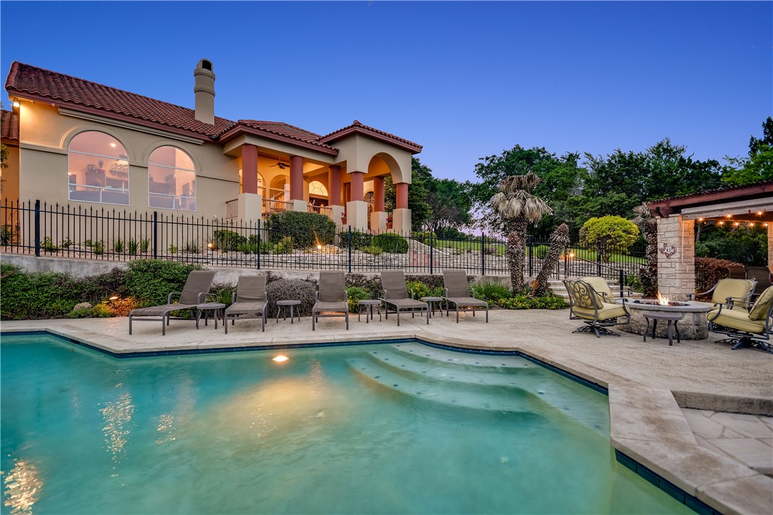 a front view of a house with swimming pool having outdoor seating