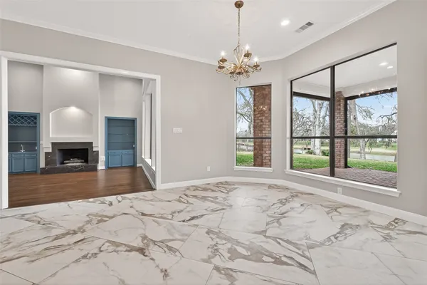 a large kitchen with kitchen island a refrigerator a sink dishwasher a oven and a dining table with wooden floor