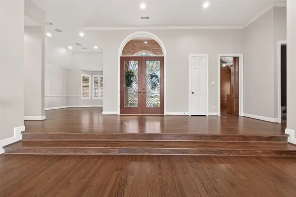 a view of a livingroom with wooden floor and a large window