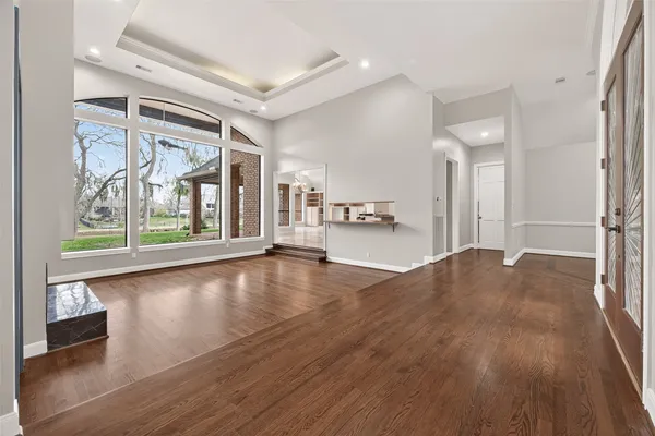 a view of empty room with wooden floor and fireplace