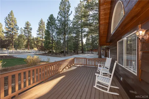 a view of balcony with wooden floor and outdoor seating