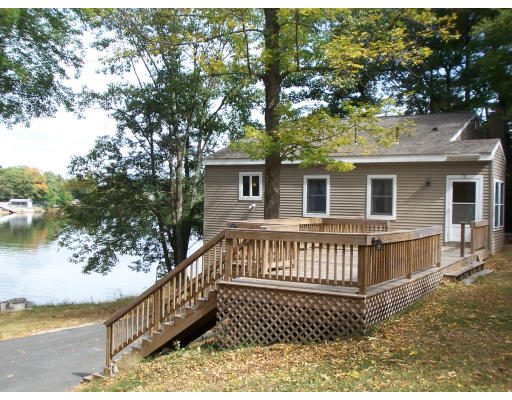 171 Mashapaug Road Holland, MA 01521 - Photo 3 of 9 a view of a house with a wooden deck