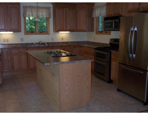 171 Mashapaug Road Holland, MA 01521 - Photo 5 of 9 a kitchen with a sink stove and refrigerator