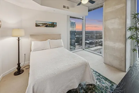 a view of a room that has a bed and a window