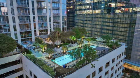 a front view of a building with a garden and plants