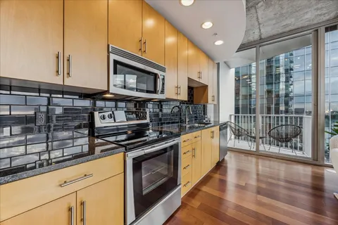 a kitchen with stainless steel appliances granite countertop a stove and a sink