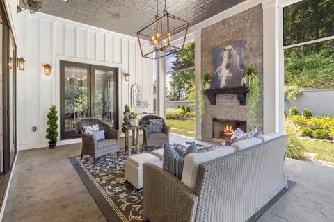 a view of house with yard outdoor seating and covered with furniture