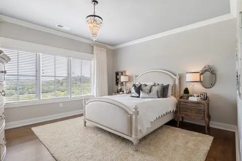 a kitchen with stainless steel appliances granite countertop a sink a stove a dining table and chairs