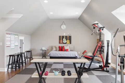 a bedroom with a bed a table and chair