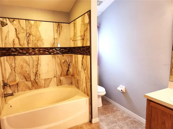 a bathroom with a bathtub and a toilet