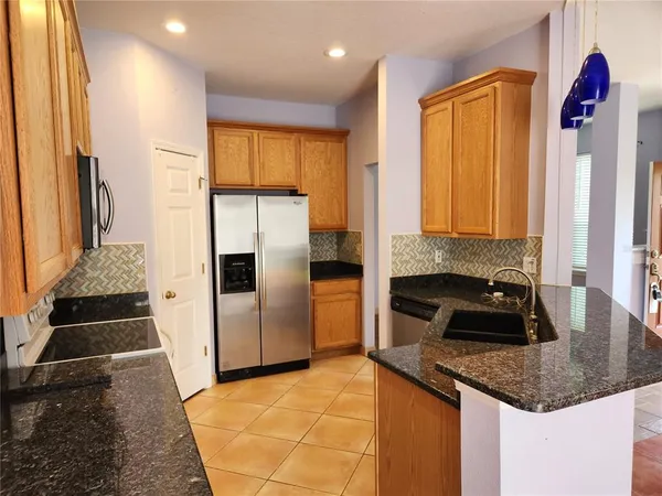a kitchen with a sink and a refrigerator