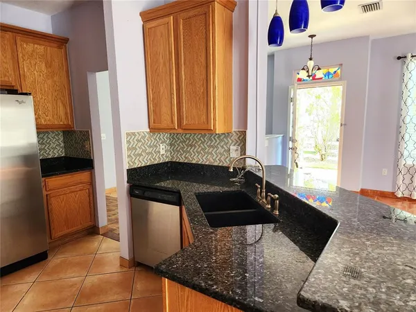a kitchen with a sink stove and a refrigerator