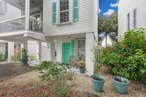 a view of a house with patio and potted plants