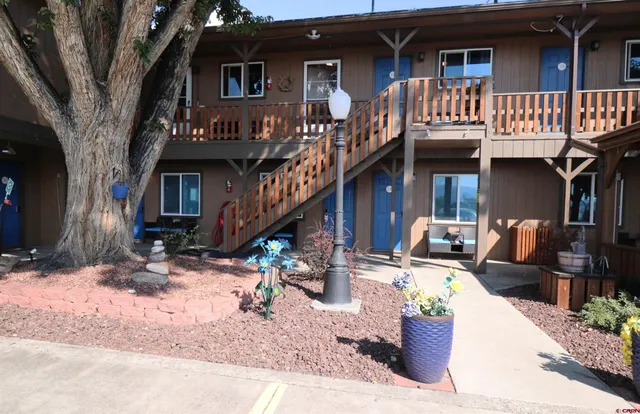 a backyard of a house with outdoor seating