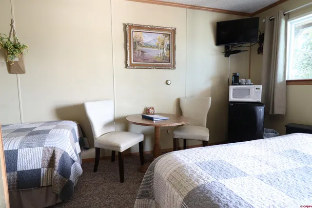 a bedroom with a bed and a chair